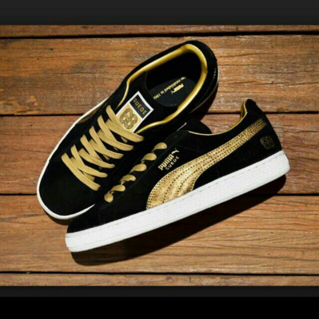 black and gold suede pumas