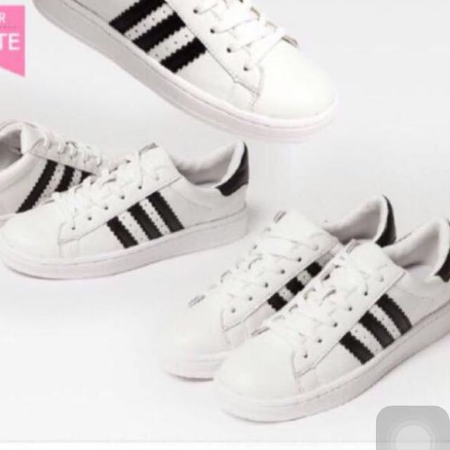 white shoes with three black stripes