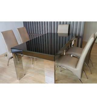 Modern glass-top dining table with six(6) leather re-upholstered chairs