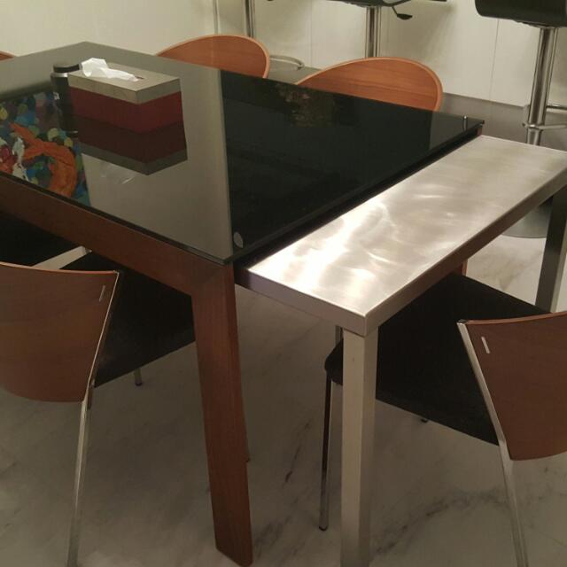 Dinner Table (Category: Tables & Sets) located in Singapore. Submitted by stuff88 (Listing ID 53090800, Image 3). Description: Extendable dining table. Table is 1.5m long and can be extended to 3.0m by simply pulling the stainless steel table underneath as shown. Flexible space saver with class. Table legs and frame is made of teak wood with beautiful grain..
