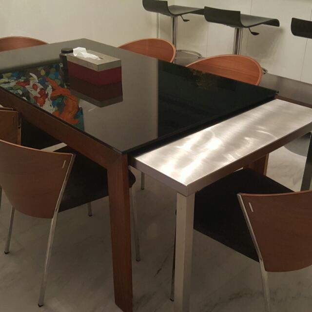 Dinner Table (Category: Tables & Sets) located in Singapore. Submitted by stuff88 (Listing ID 53090800, Image 1). Description: Extendable dining table. Table is 1.5m long and can be extended to 3.0m by simply pulling the stainless steel table underneath as shown. Flexible space saver with class. Table legs and frame is made of teak wood with beautiful grain..