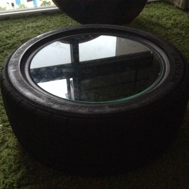 Tyre table with store glass top