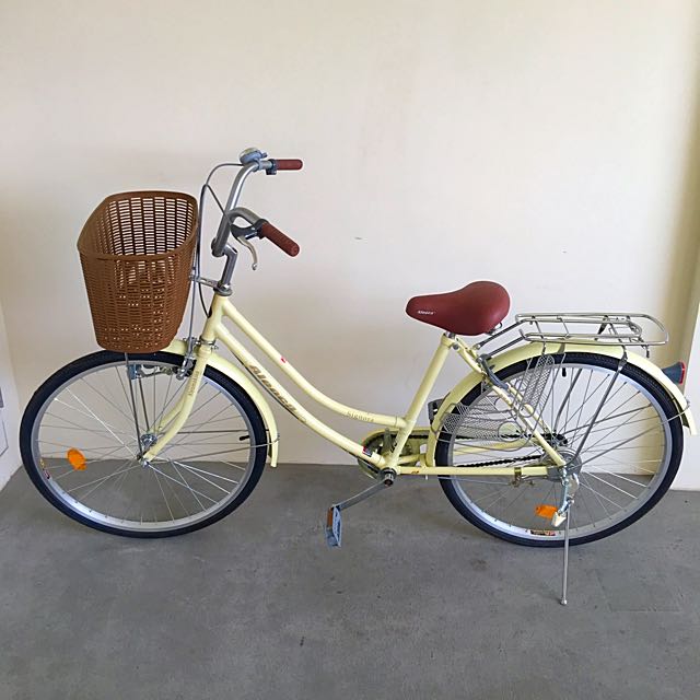 pastel yellow bike with basket