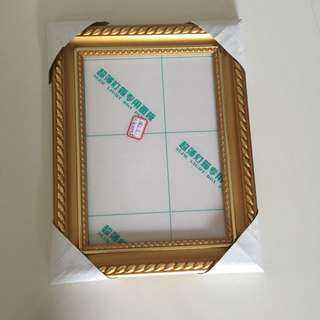 gold rimmed standing photo frame