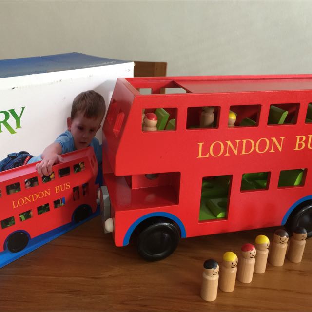 wooden london bus with passengers