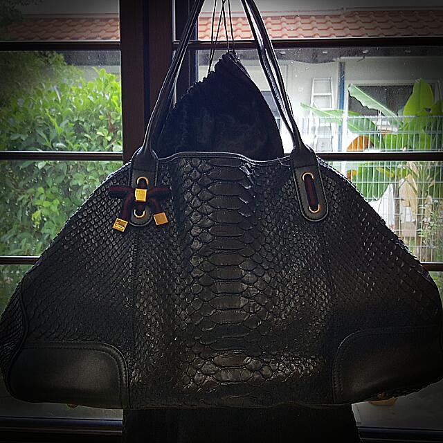 Gucci Black Python Shoulder Bag (Category: Bags & Wallets) located in Singapore. Submitted by potters (Listing ID 72667734, Image 1). Description: Authentic Overall good condition including inner lining Comes with dust bag Very spacious Approximate measurements: L: 46cm H: 27cm D: 12cm.