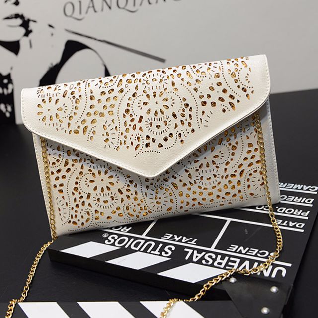 white and gold clutch bag