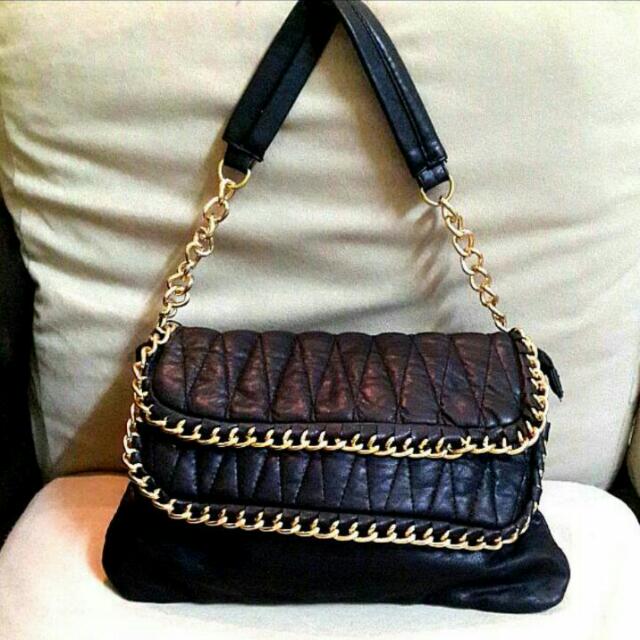 black purse with gold chain strap
