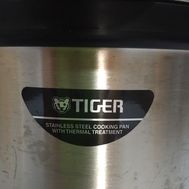 Tiger stainless steel cooking pan with thermal treatment outlet
