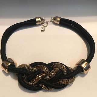 gold and black necklace