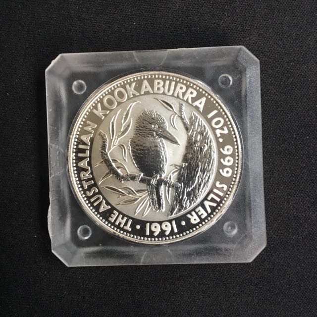 1991 Perth Mint Silver Kookaburra Coin (Category: Currency) located in Singapore. Submitted by coinsandstamps (Listing ID 105346161, Image 1). Description: 1oz 999 silver coin in original square capsule with box. Perfect condition. 2pcs available, price shown is for 1 pc..