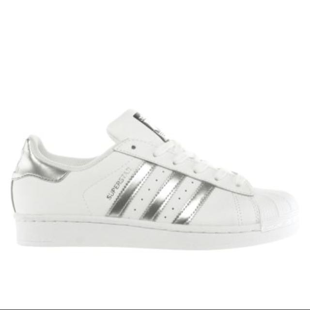 white adidas with silver stripes
