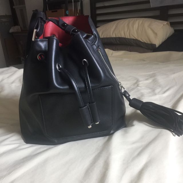 black bucket bag with red lining