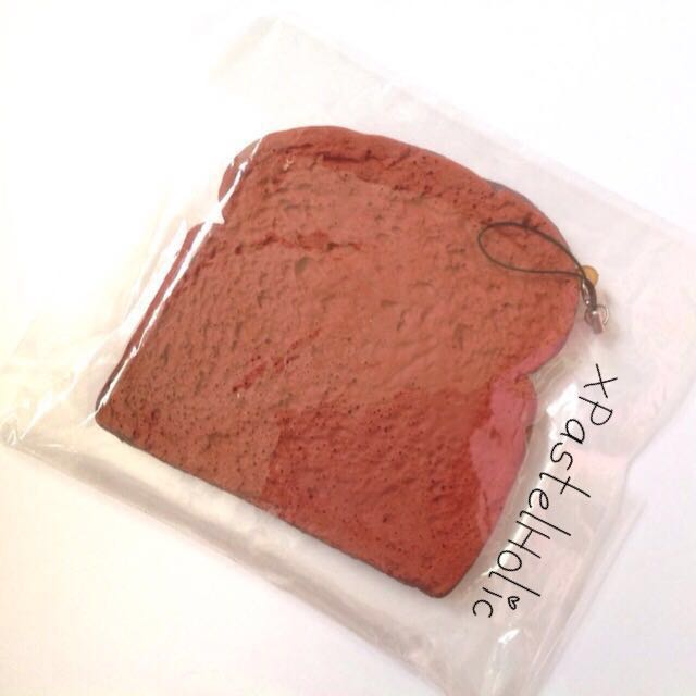 Bread Slice Squishy (Category: Plushies & Soft Toys) located in Singapore. Submitted by xpastelholic (Listing ID 54886124, Image 1). Description: - BNIP - Super squishy - Comes with black cellphone strap.