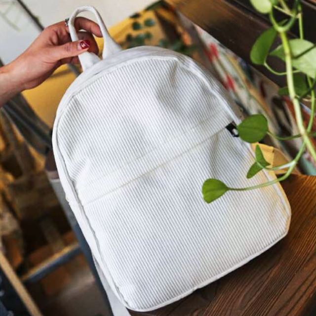 white corduroy backpack