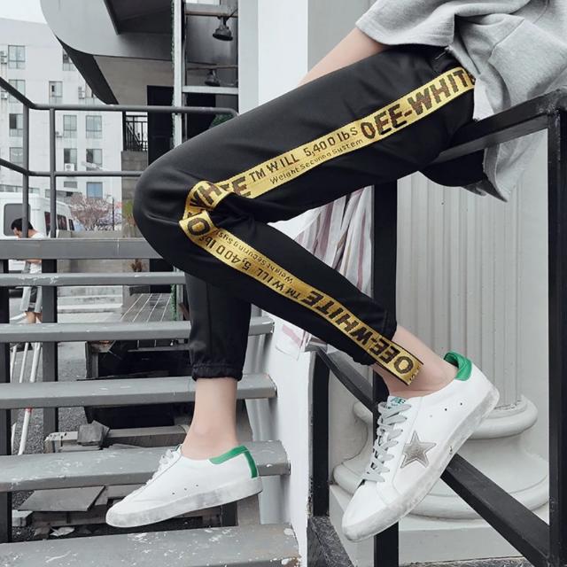 Off white pants with yellow new arrivals stripe