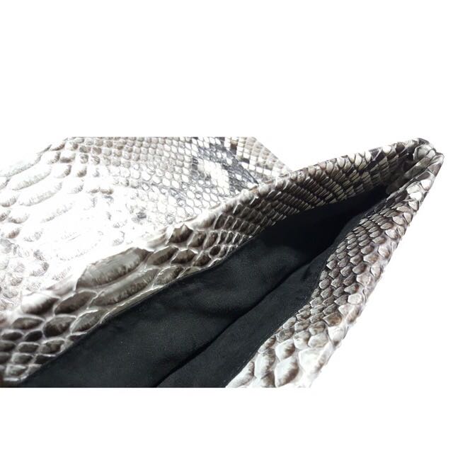 Genuine python envelop clutch (Category: Other Accessories) located in Singapore. Submitted by starryz (Listing ID 139384146, Image 4). Description: Item Details: - Full-Grain Genuine Python belly Leather and fully lined with leather - Interior card pocket - Flap secured with magnetic closure - Handcrafted with love Condition: New Size: 10" W "x 6" H Reasons Why You Should Get This: Looking for a unique accessory to compliment your upcoming Chris