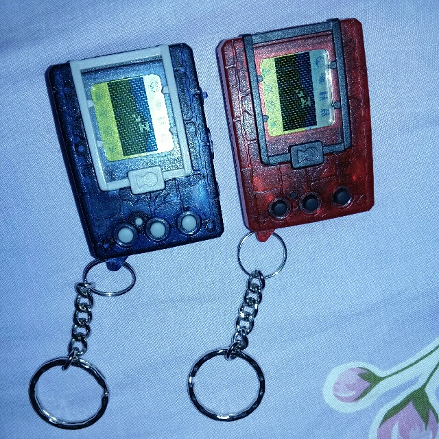 digimon version 1 (Category: Interactive Toys) located in Singapore. Submitted by ben_xio (Listing ID 146831713, Image 2). Description: tip top new sparkling ver 1997 english USa/europe version twin pair transparent swee! near extinction~ 2 for 400.