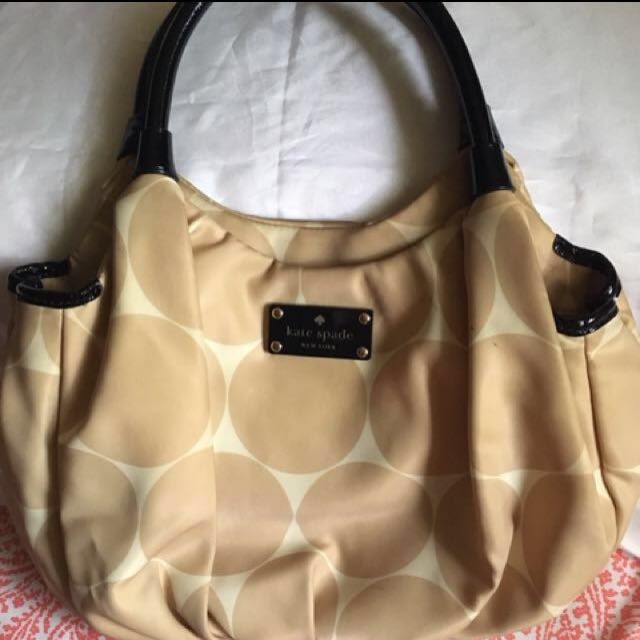 Authentic Kate Spade hobo bag (Category: Luxury Bags & Wallets) located in Quezon City. Submitted by closet_access (Listing ID 141525986, Image 1). Description: •guaranteed 💯 authentic, personally bought in Hong Kong •made of soft silk material with circle pattern •color: gold •comes with original Kate Spade paper bag •flaws: there are some dirt marks from storage and stains probably from the rubber piping of the handle; needs some cleaning, but