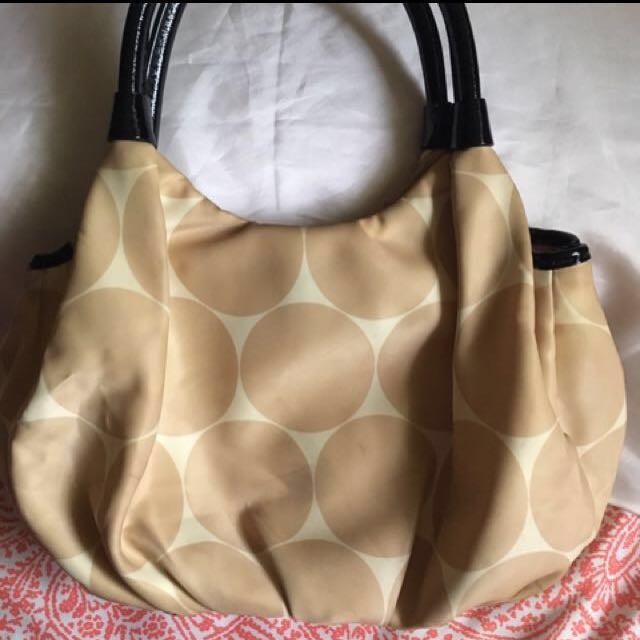 Authentic Kate Spade hobo bag (Category: Luxury Bags & Wallets) located in Quezon City. Submitted by closet_access (Listing ID 141525986, Image 2). Description: •guaranteed 💯 authentic, personally bought in Hong Kong •made of soft silk material with circle pattern •color: gold •comes with original Kate Spade paper bag •flaws: there are some dirt marks from storage and stains probably from the rubber piping of the handle; needs some cleaning, but