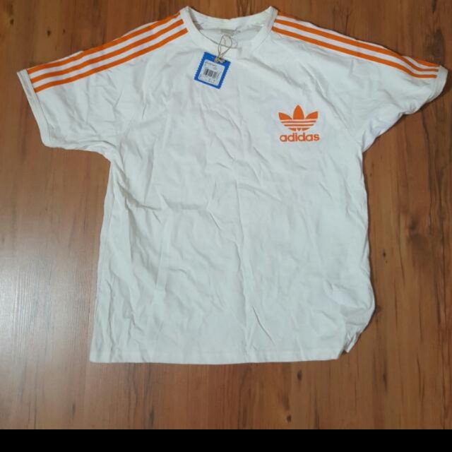 White adidas sales with orange stripes