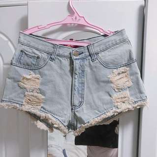 Tattered ripped denim shorts