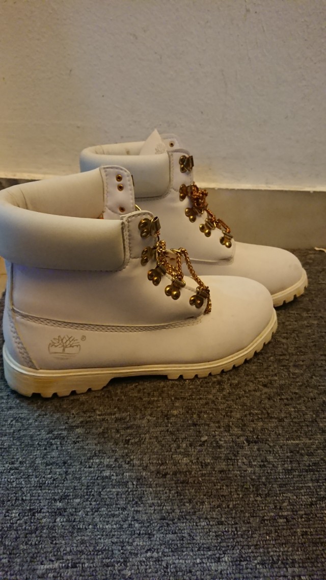 All white timberlands top with gold chain laces