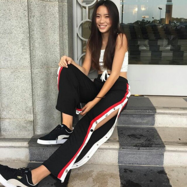 black pants with red and white stripe down side