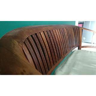 Wooden bench with cushion.