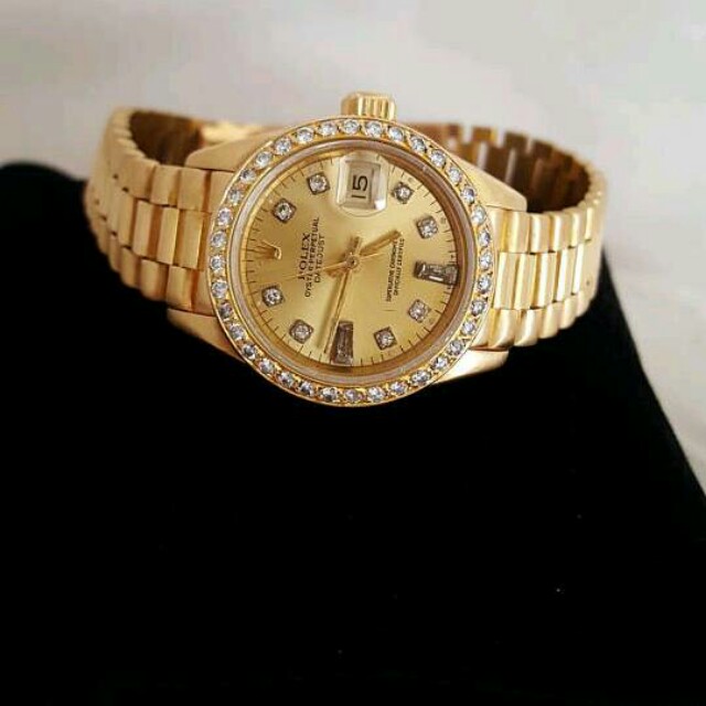Rolex (Category: Looking For) located in Alma. Submitted by joeman88 (Listing ID 160246425, Image 2). Description: Pre-owned Rolex Lady President 69178 in solid 18K Yellow Gold in as new condition. This watch has the original Factory Champagne Diamond dial and a custom added 1.5CT Channel-set Diamond bezel. 1990's production. Sapphire crystal and quick-set date feature..