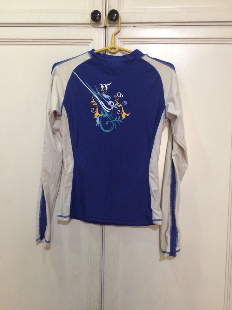 Sassa Blue and White Long-Sleeved Rashguard (Category: Rash guard) located in Makati City. Submitted by clawdjaa (Listing ID 163457253, Image 1). Description: Blue and white long-sleeved rashguard with cute yellow design in front.