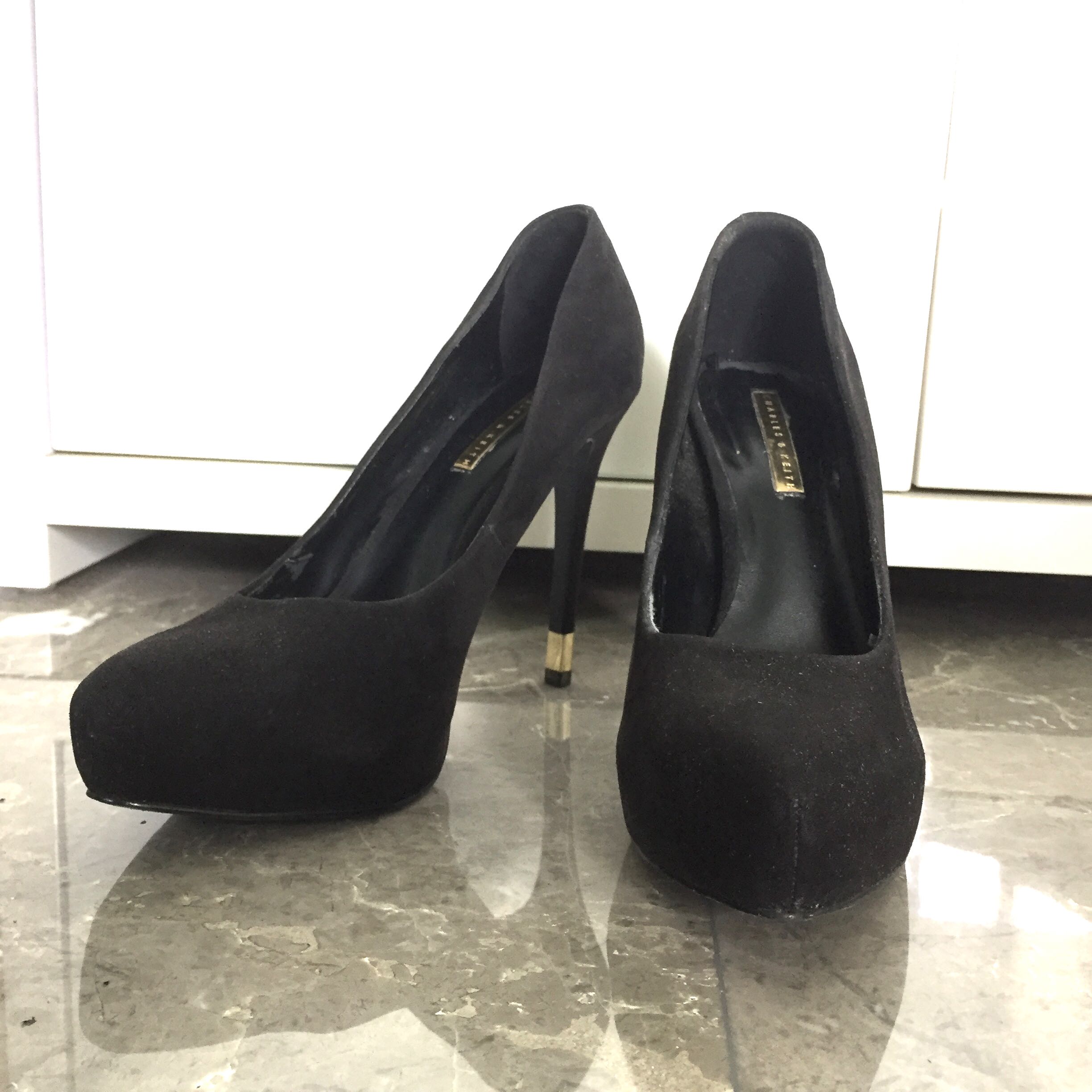 black stilettos with gold heels