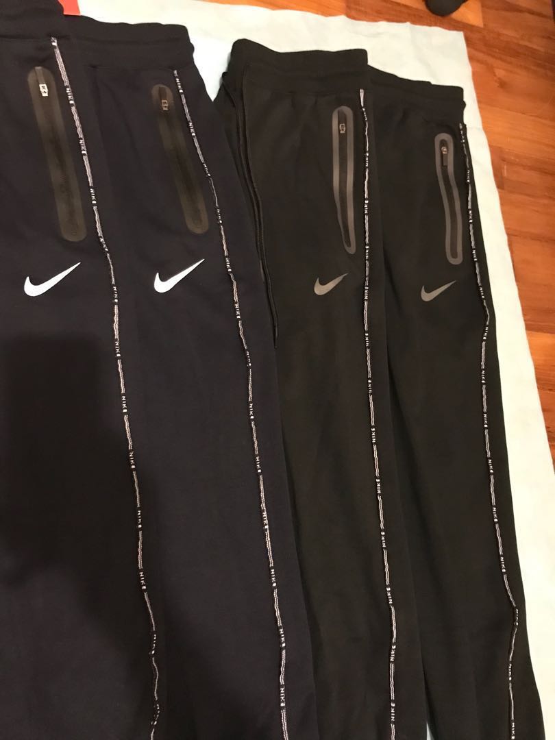 Nike track pants zippered pockets hot sale