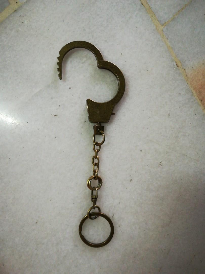 Handcuff Keychain (Category: Accessory holder, box & organisers) located in Kuala Lumpur. Submitted by bbcng (Listing ID 176205513, Image 2). Description: Item : handcuff Keychain Color : Bronze Materials : metal Size : 6 1/2" total long 1" handcuff diameter 2" handcuff Itself Long Price : Rm20 Peninsular Rm 25 Sabah & Sarawak Delivery method : pos laju Payment method : Maybank Transfer.