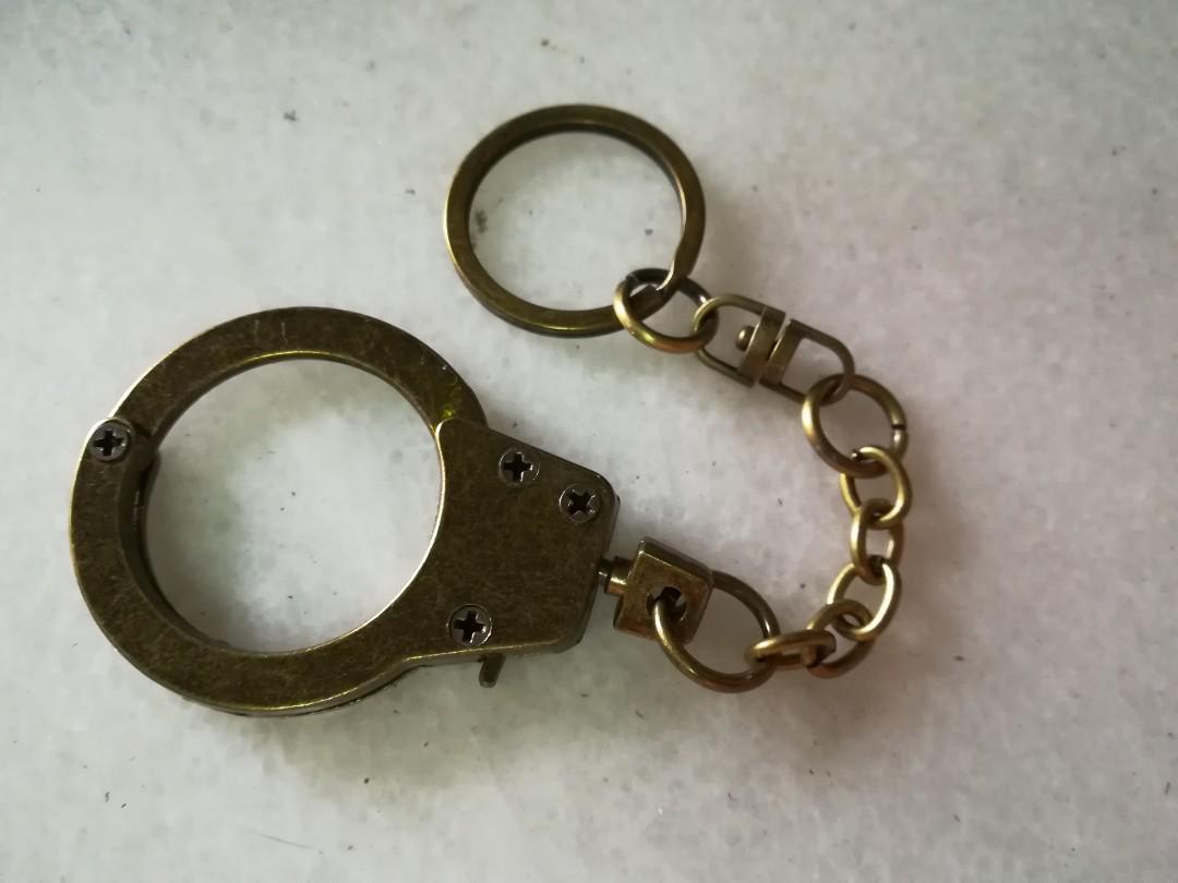 Handcuff Keychain (Category: Accessory holder, box & organisers) located in Kuala Lumpur. Submitted by bbcng (Listing ID 176205513, Image 1). Description: Item : handcuff Keychain Color : Bronze Materials : metal Size : 6 1/2" total long 1" handcuff diameter 2" handcuff Itself Long Price : Rm20 Peninsular Rm 25 Sabah & Sarawak Delivery method : pos laju Payment method : Maybank Transfer.