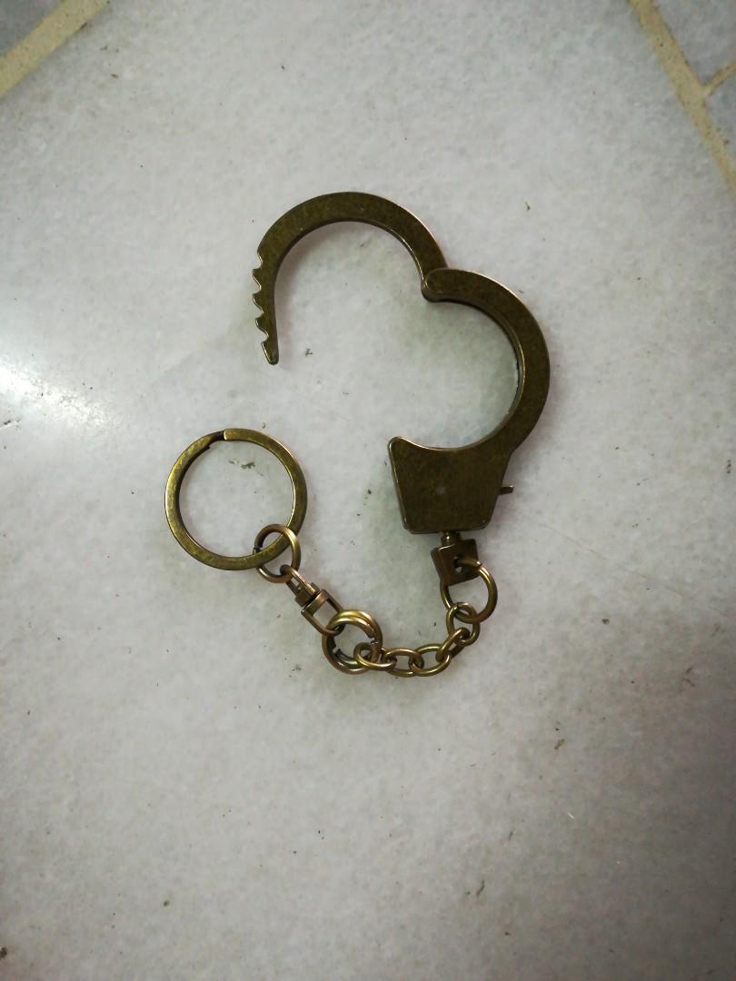 Handcuff Keychain (Category: Accessory holder, box & organisers) located in Kuala Lumpur. Submitted by bbcng (Listing ID 176205513, Image 3). Description: Item : handcuff Keychain Color : Bronze Materials : metal Size : 6 1/2" total long 1" handcuff diameter 2" handcuff Itself Long Price : Rm20 Peninsular Rm 25 Sabah & Sarawak Delivery method : pos laju Payment method : Maybank Transfer.