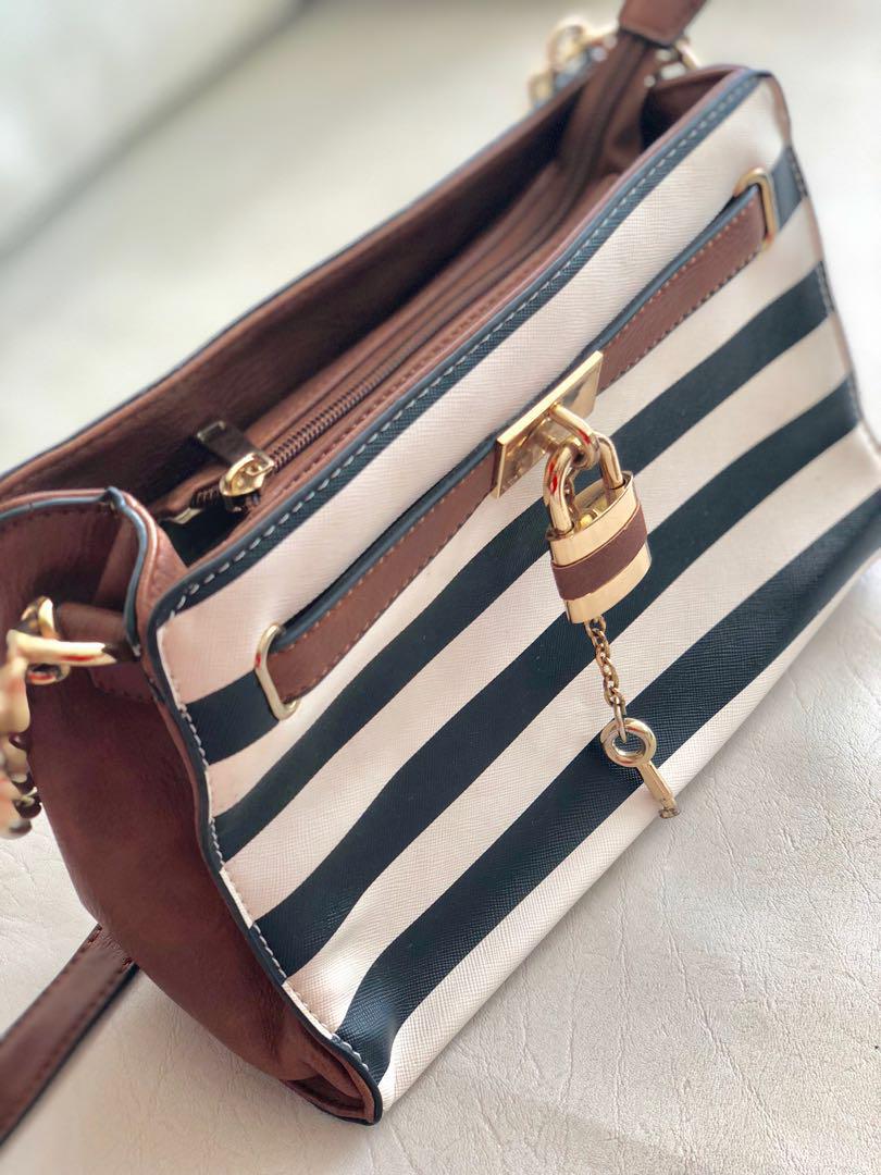 Aldo Nautical Sling Bag (Category: Cross-body Bags) located in Quezon City. Submitted by wynch_stuff (Listing ID 176260317, Image 2). Description: 🔸 Brand: Aldo 🔸 nautical design with lock and key accent design 🔸 sling bag 🔸 Color: White and navy blue 🔸 leatherette 🔸 Measurements: Length: 9.5in Height: 7in Width: 3.5in 🔸 two main compartment with middle zipper pocket 🔸 adjustable shoulder strap 🔸Condition: Seldom-used, Mint condition, wi