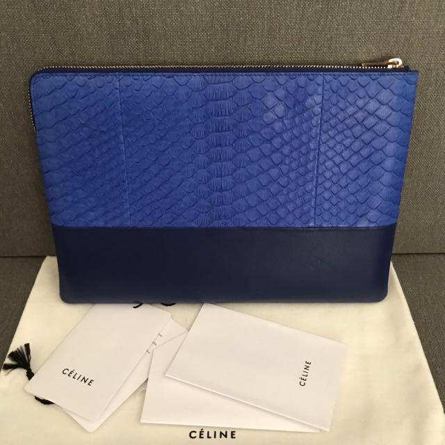 Celine Solo Clutch Pouch Python Skin (Category: Luxury Bags & Wallets) located in Manila. Submitted by bagstagram (Listing ID 134228420, Image 2). Description: Blue python and lamb skin leather Céline Solo Pouch with gold-tone hardware, logo at front exterior and zip closure at top. Includes dust bag. Python is a premiere leather. Price reflects this. Height: 7" Width: 9.25" Depth: 0.25 Retail: SGD 1,300 Condition: Like New .