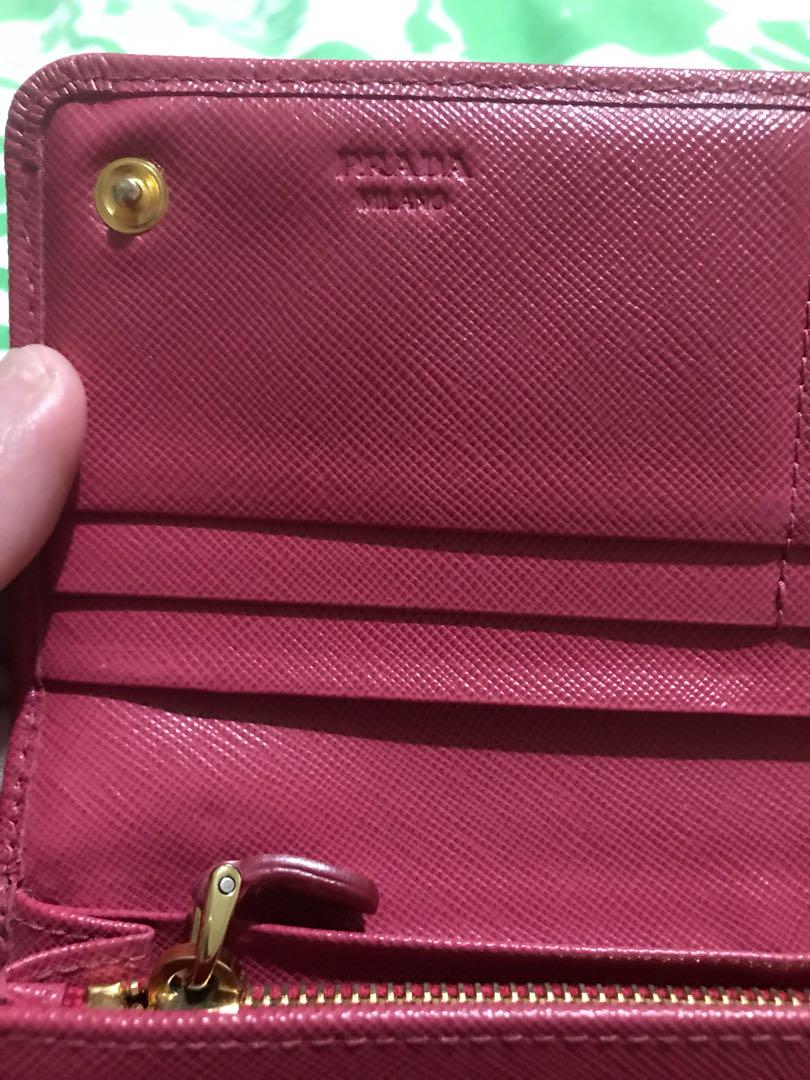 FIRM ON PRICE. Authentic Prada Saffiano long wallet (Category: Luxury Bags & Wallets) located in Quezon City. Submitted by luxuryphloved (Listing ID 180070141, Image 3). Description: Store bought! Nagoya Japan Branch. With Authenticity card, serial number, and model certificate, no box. Authentic Prada Saffiano Fuschia pink long wallet :) No tears, kindly review pics :) No major flaws, just faded edges. You can have it recolored if you want :) .