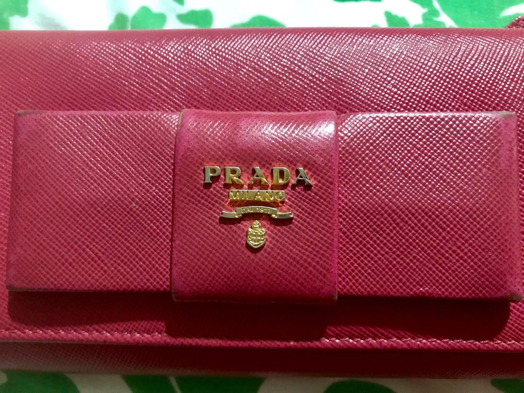 FIRM ON PRICE. Authentic Prada Saffiano long wallet (Category: Luxury Bags & Wallets) located in Quezon City. Submitted by luxuryphloved (Listing ID 180070141, Image 2). Description: Store bought! Nagoya Japan Branch. With Authenticity card, serial number, and model certificate, no box. Authentic Prada Saffiano Fuschia pink long wallet :) No tears, kindly review pics :) No major flaws, just faded edges. You can have it recolored if you want :) .