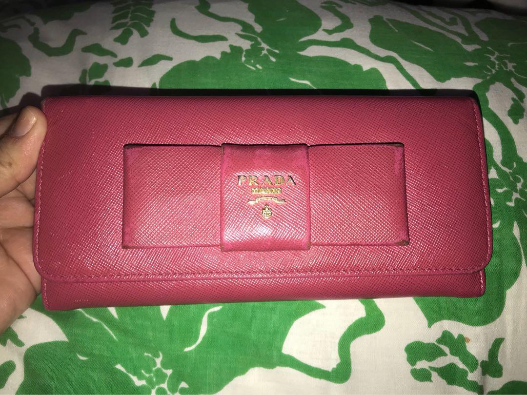 FIRM ON PRICE. Authentic Prada Saffiano long wallet (Category: Luxury Bags & Wallets) located in Quezon City. Submitted by luxuryphloved (Listing ID 180070141, Image 1). Description: Store bought! Nagoya Japan Branch. With Authenticity card, serial number, and model certificate, no box. Authentic Prada Saffiano Fuschia pink long wallet :) No tears, kindly review pics :) No major flaws, just faded edges. You can have it recolored if you want :) .