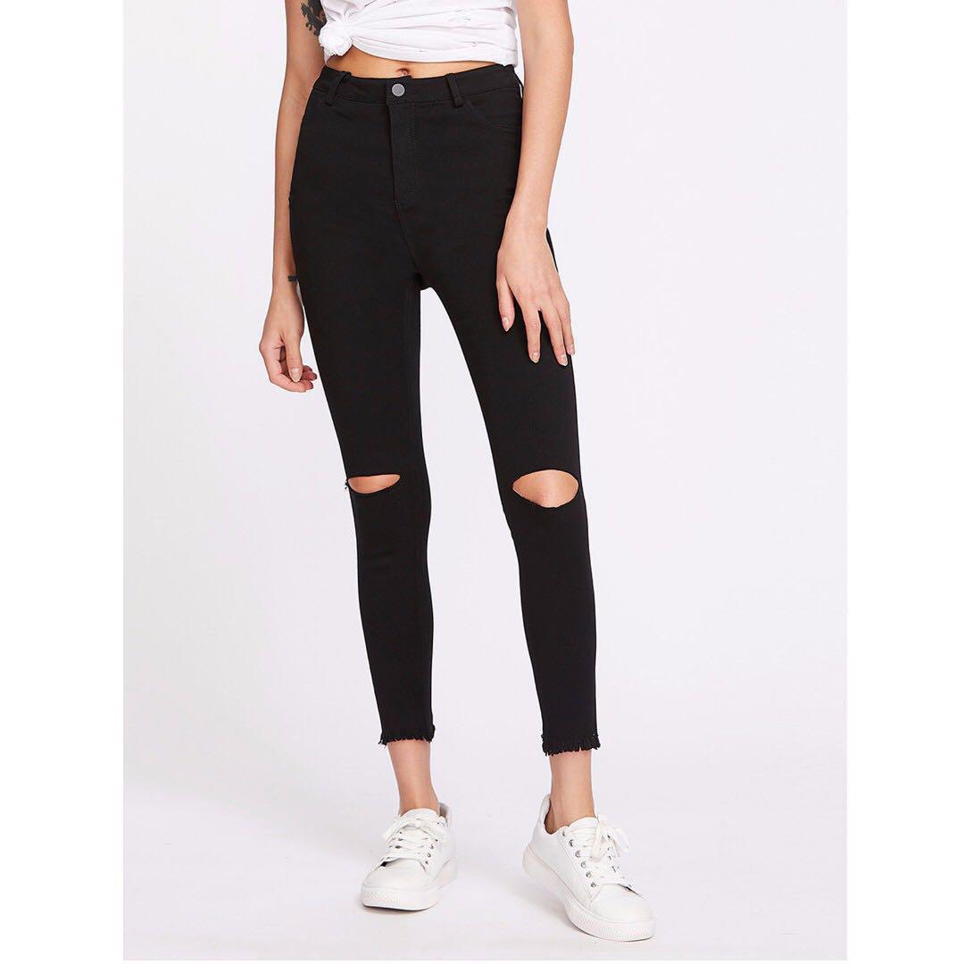 black jeans with knee cuts