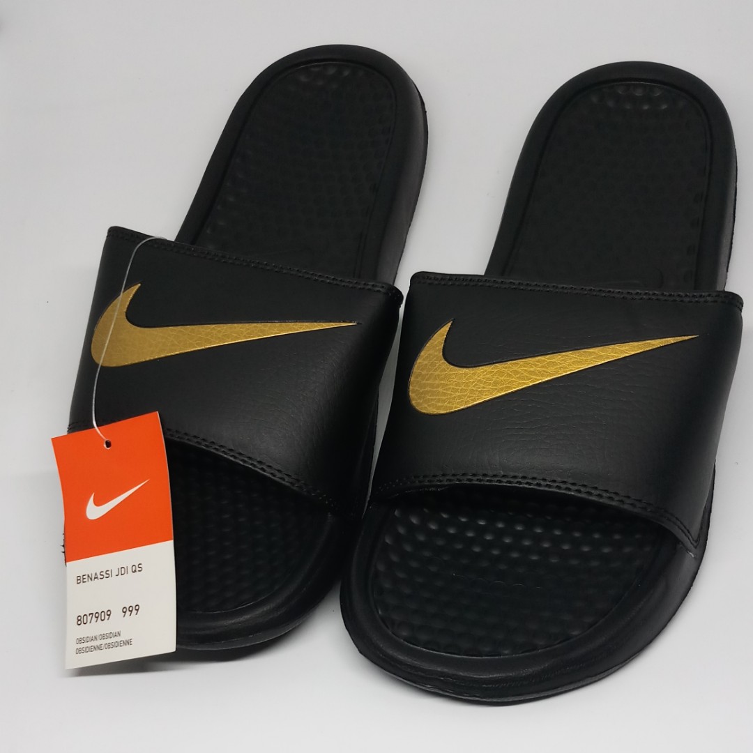 nike slippers with gold logo