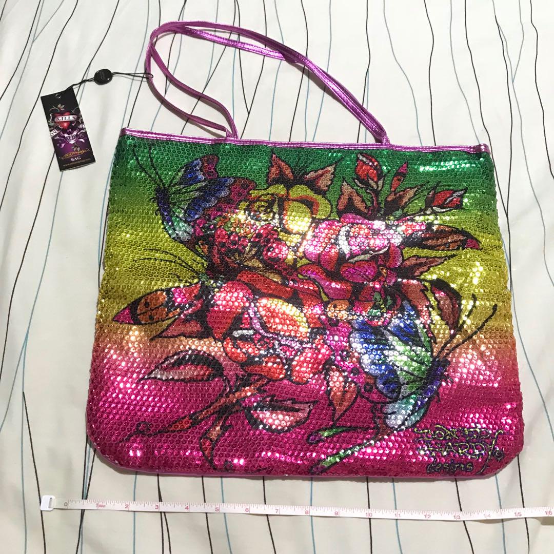 Brand New Ed Hardy Tote Bag (Category: Tote Bags) located in Laoag. Submitted by xokate (Listing ID 185221431, Image 1). Description: Price: ₱520 (retails at $59 but bought for $39 or ₱2000) Brand: Ed Hardy (by Christian Audigier) Type: Tote bag Condition: Brand new/never used with tag Dimensions: 15x15 inches Material: See last photo Color: Multi ++ recycled materials & prominent designer! 🤩.