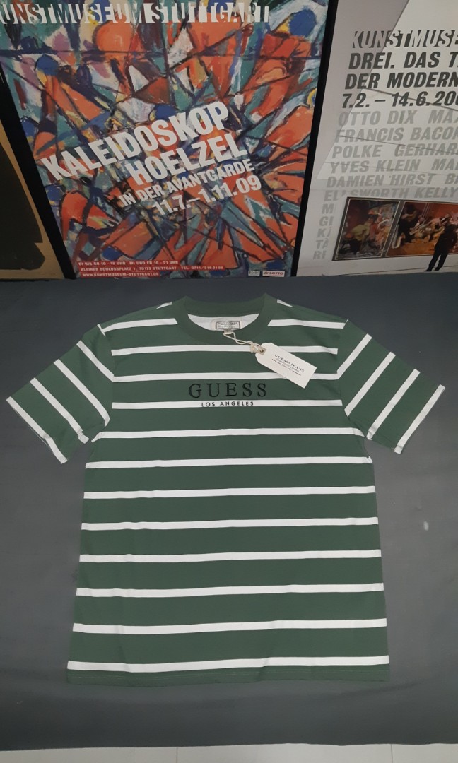 green and white guess shirt