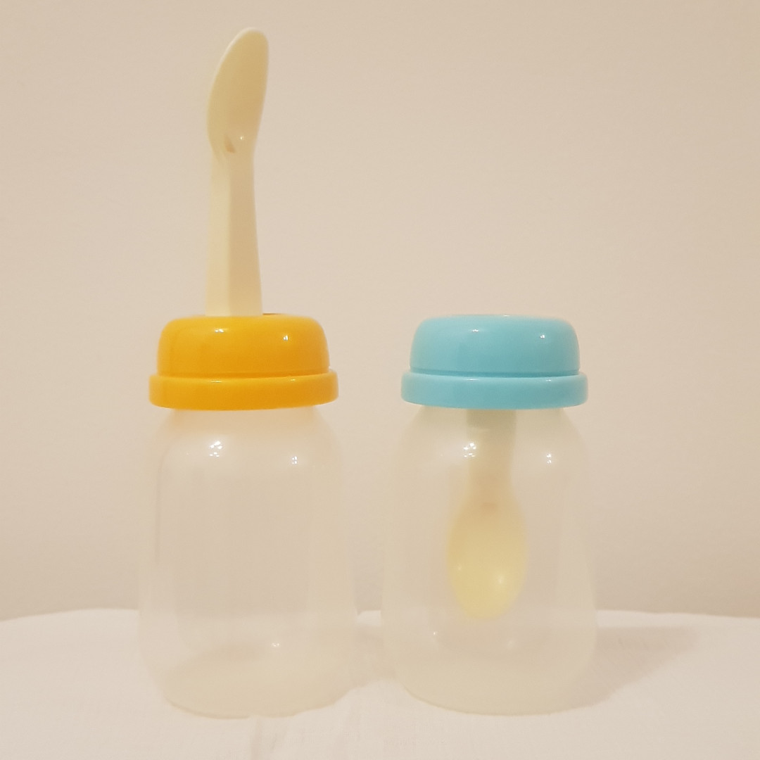 baby bottle with spoon attached