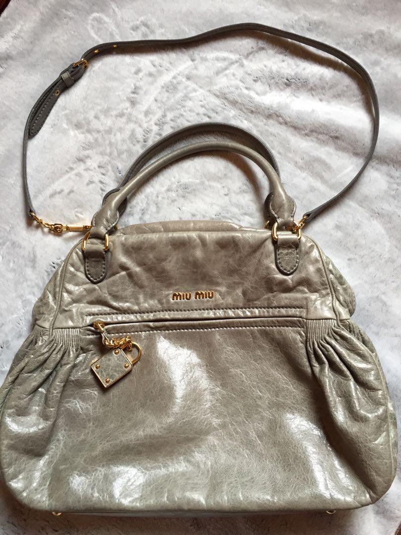 MIU MIU Vitello Bowler Bag (Category: Luxury Bags & Wallets) located in Bulacan. Submitted by relovedbydei (Listing ID 185429345, Image 1). Description: Miu Miu Prada Shiny Vitello Lux Gray Glazed Nappa Leather Bowler Bag Gray leather exterior, satin fabric lining in gold tone hardware. Dual snap closure Leather chain and lock fob Metal logo detail Zippered exterior pocket Detachable shoulder strap .