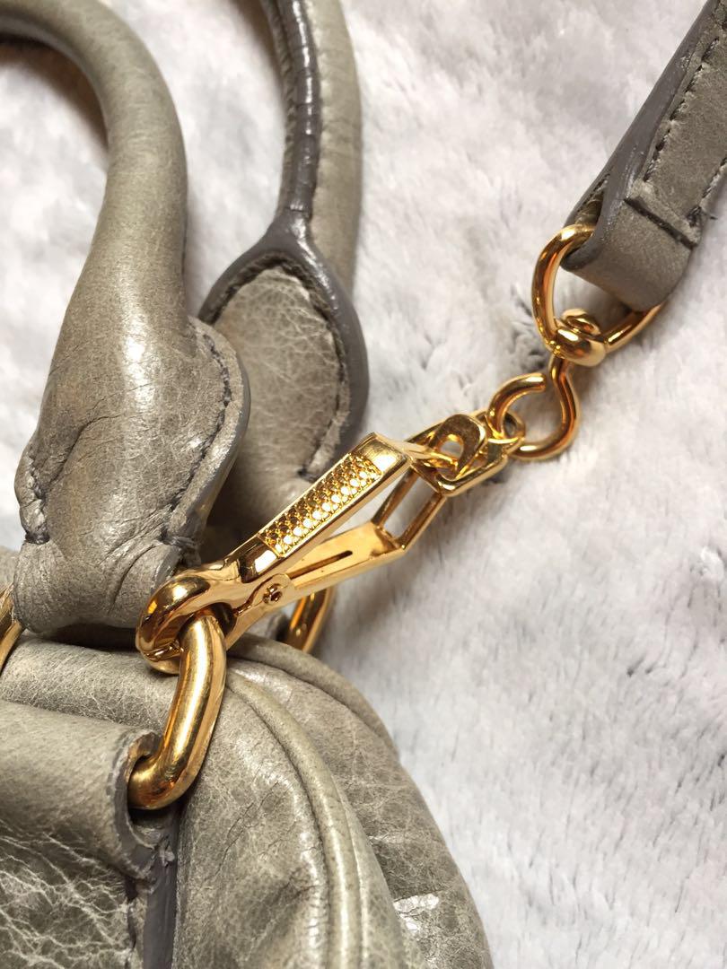MIU MIU Vitello Bowler Bag (Category: Luxury Bags & Wallets) located in Bulacan. Submitted by relovedbydei (Listing ID 185429345, Image 3). Description: Miu Miu Prada Shiny Vitello Lux Gray Glazed Nappa Leather Bowler Bag Gray leather exterior, satin fabric lining in gold tone hardware. Dual snap closure Leather chain and lock fob Metal logo detail Zippered exterior pocket Detachable shoulder strap .