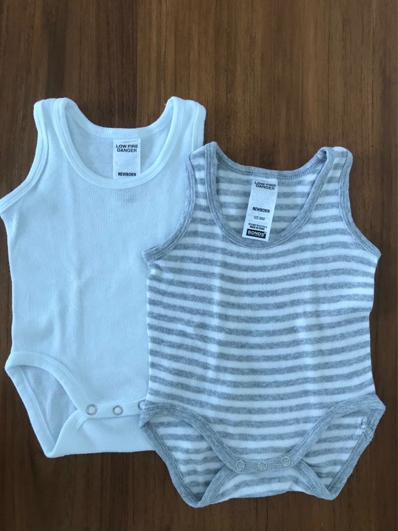 white sleeveless baby vests