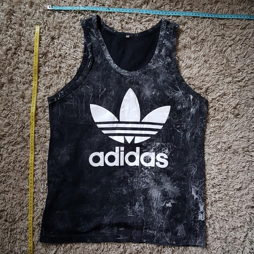 Assorted Singlets (Category: Tshirts & Polo Shirts) located in Singapore. Submitted by grabquick (Listing ID 190102874, Image 4). Description: Selling some singlets purchased from my trips to Thailand! Buy 1 for $8. Growing your wardrobe? Buy 2 at $15. Buy 3 at $22. Buy 4 at $28! All worn only once. Feels like a Male S. Adidas is slightly wider. -----SOLD OUT----- Nike (Red) Chest: 46cm Length: 65cm Condition: 8/10 Rinjani (Black) Chest: 46cm Len